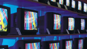 Image of a shelf full of TV's that all have stock store imagery.